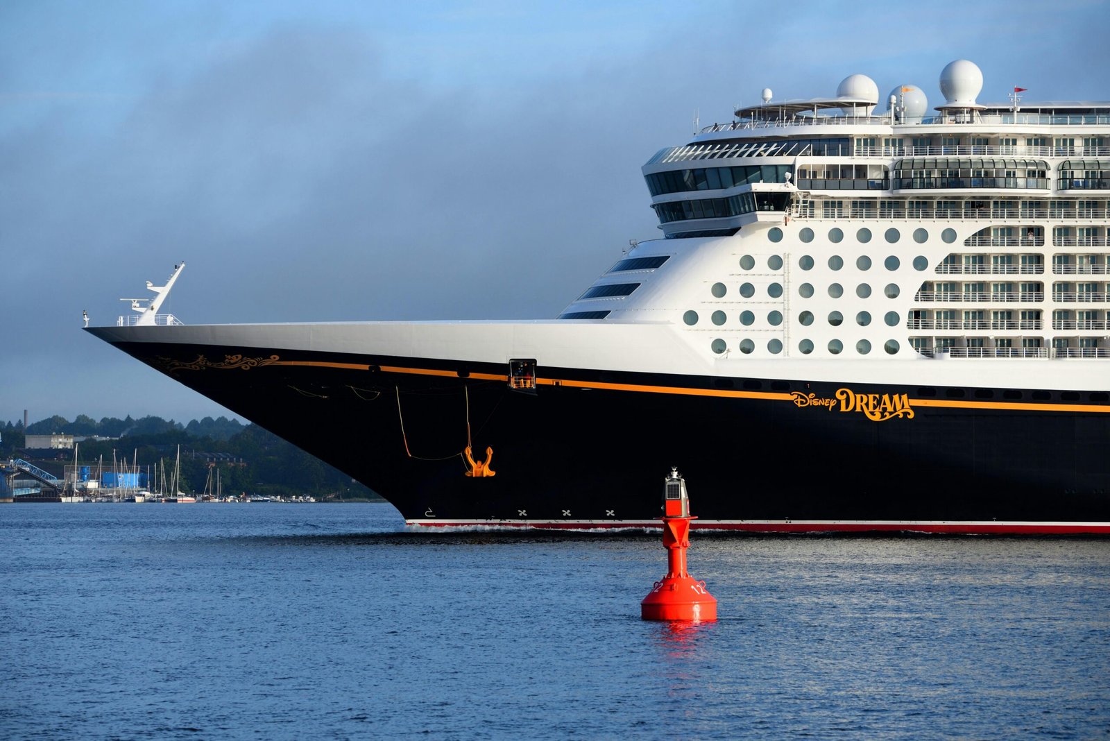 Close-up of the Disney Dream cruise ship docked in Deutschland, capturing its grandeur against a calm sea.